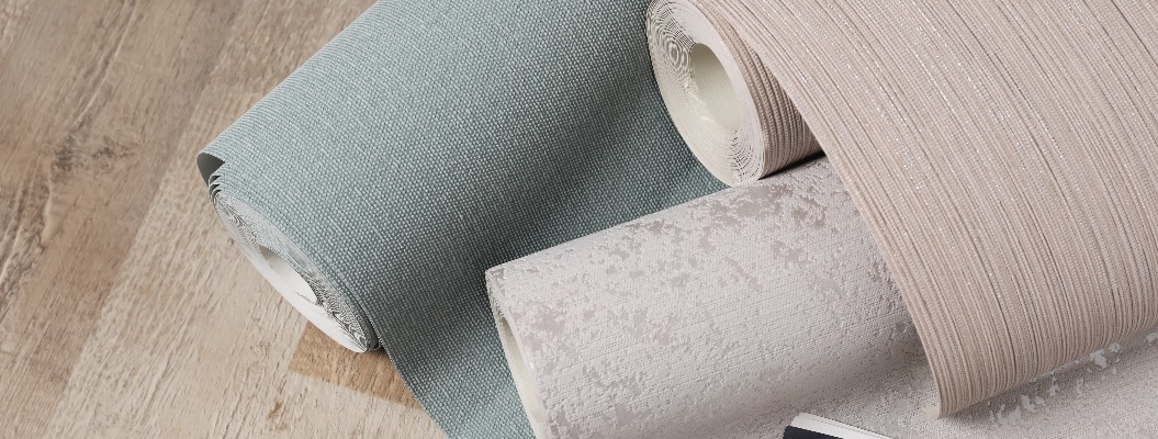Wall paper rolls and color palette on wooden floor